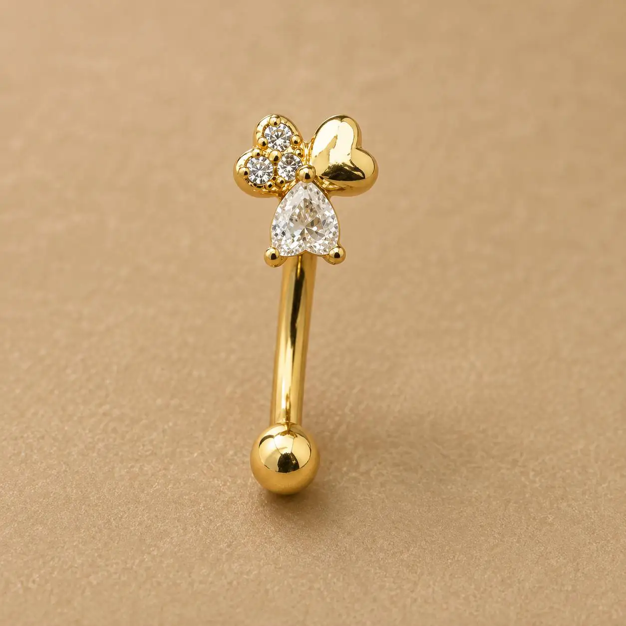 gold-bow-eyebrow-piercing-front-view پیرسینگ ابرو طلایی طرح پاپیون با نگین اشکی از نمای روبهرو