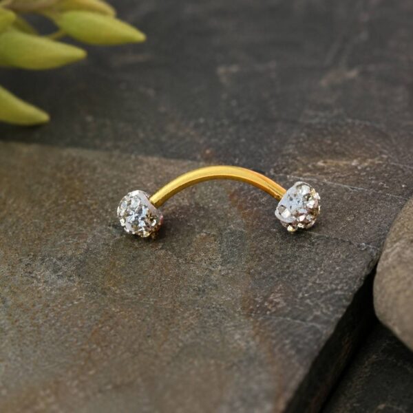 curved-gold-eyebrow-piercing-closeup.jpg