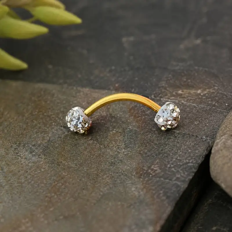 curved-gold-eyebrow-piercing-closeup.jpg