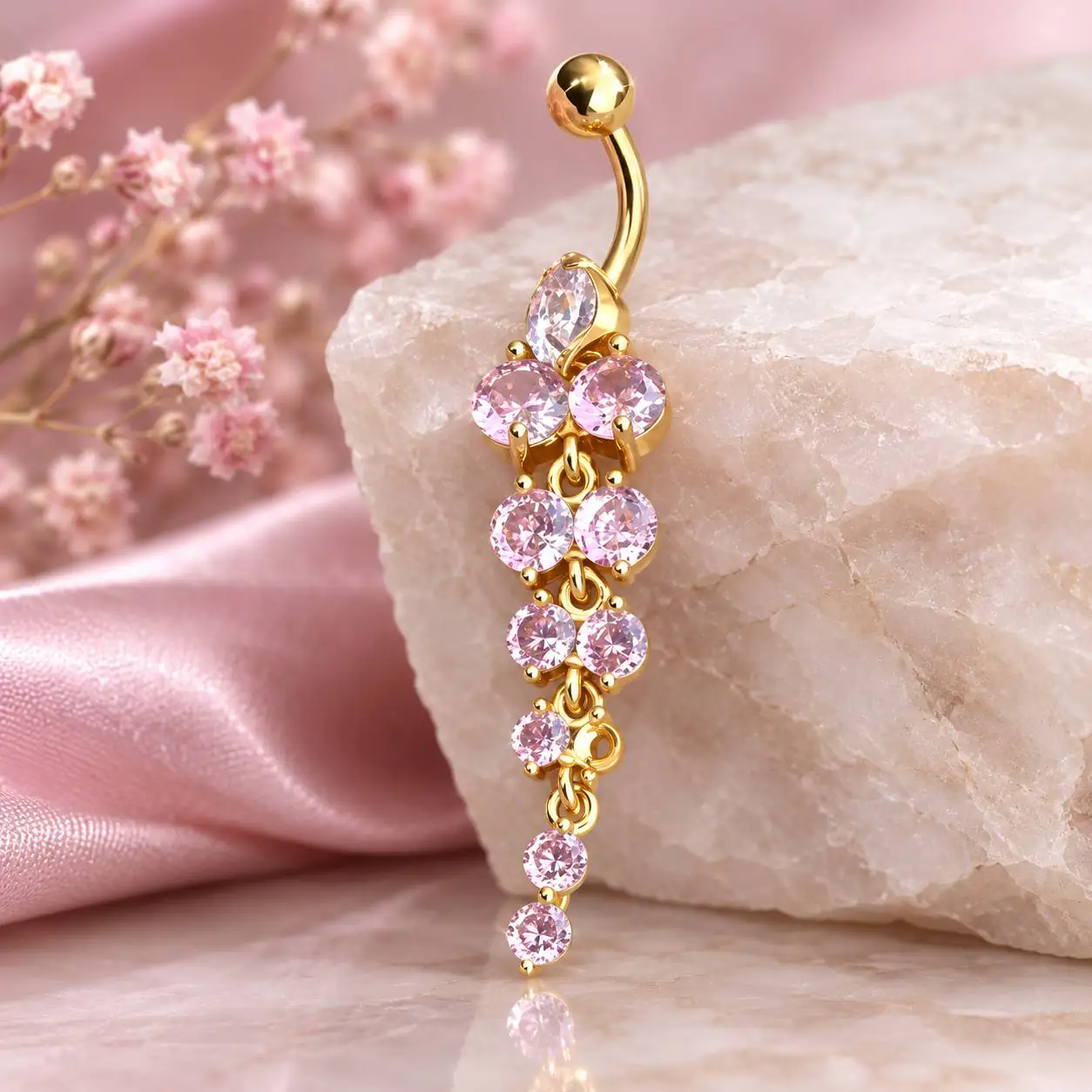gold-dangle-belly-ring-pink-stones.jpg پیرسینگ ناف آویز طلایی با نگینهای صورتی تراشخورده و طراحی آبشاری
