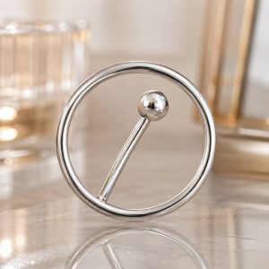 نمای نزدیک پیرسینگ ناف حلقه‌ای نقره‌ای با طراحی خاص