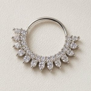 پیرسینگ سپتوم نقره‌ای نگین‌دار مدل تاجی با نگین‌های شفاف روی پس‌زمینه روشن