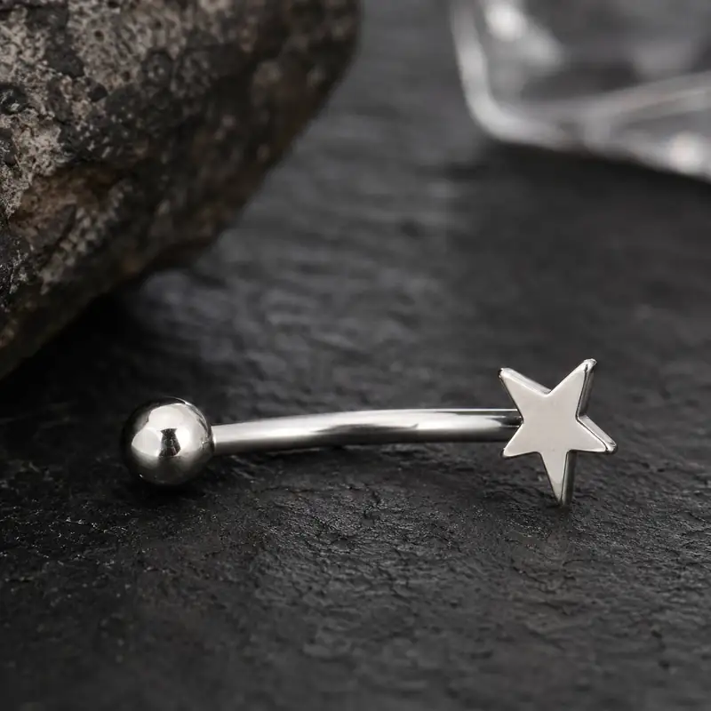 silver-eyebrow-piercing-dark-background.jpg