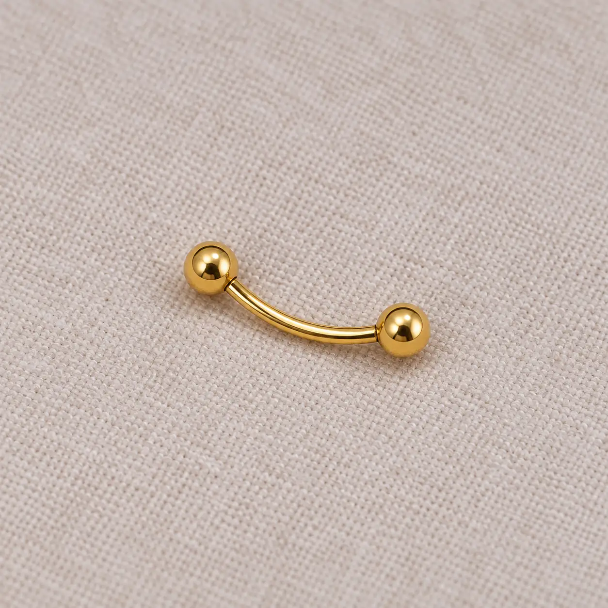 gold-curved-eyebrow-barbell-medium.webp