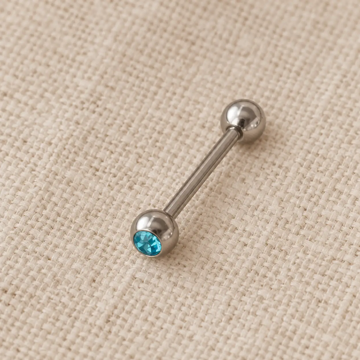 silver-blue-gem-cheek-piercing.webp