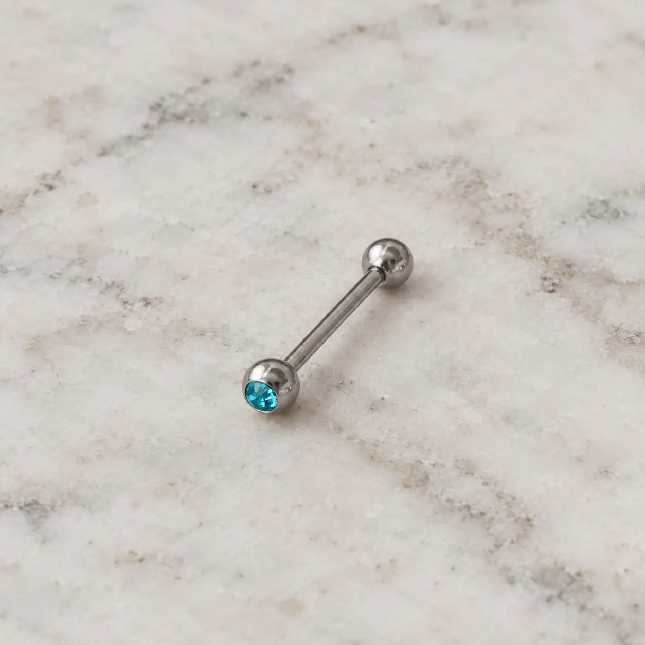 turquoise-barbell-piercing-silver.webp پیرسینگ میلهای دو سر گرد با نگین آبی فیروزهای